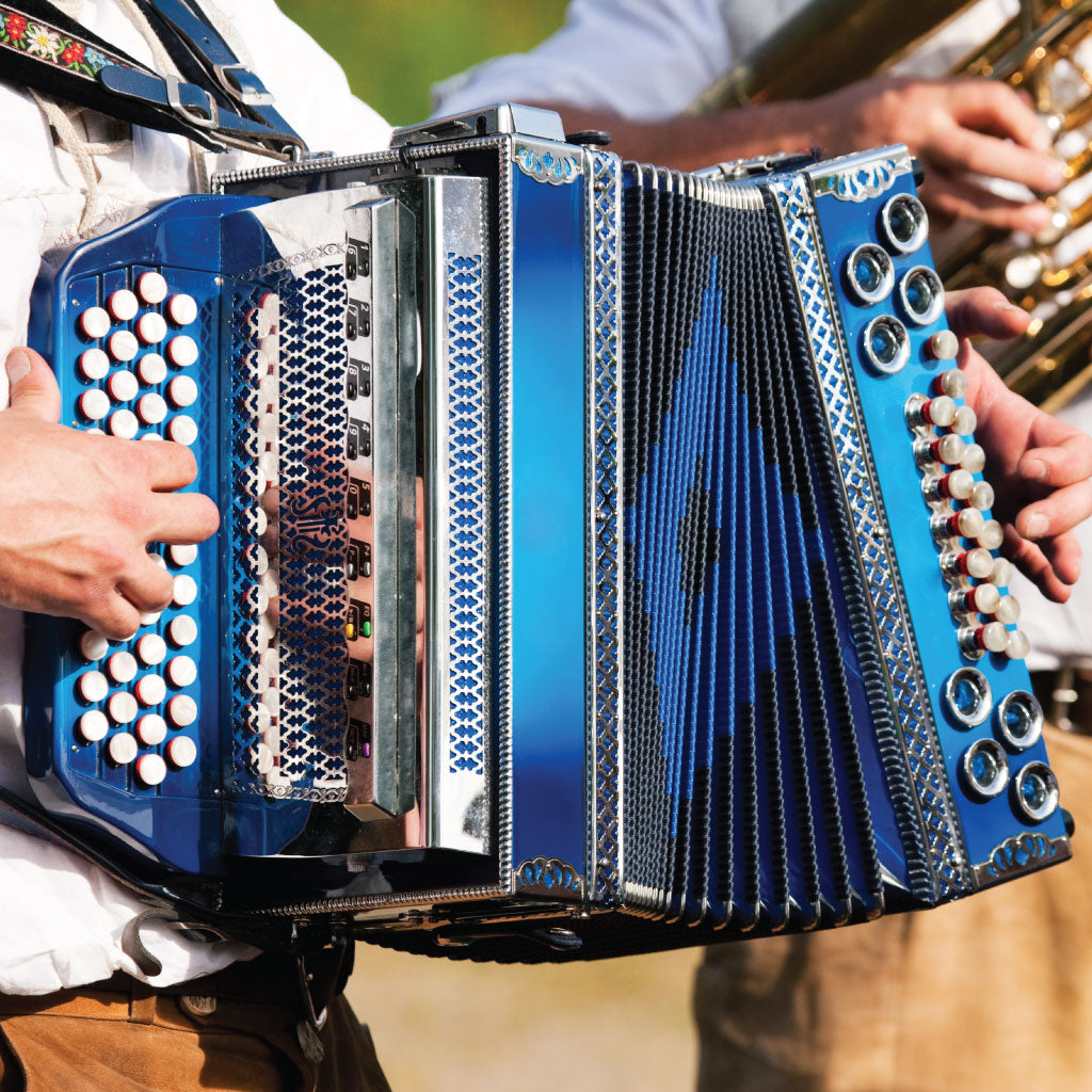 Cropped image of a man in traditional folk atire, playing the melodeon