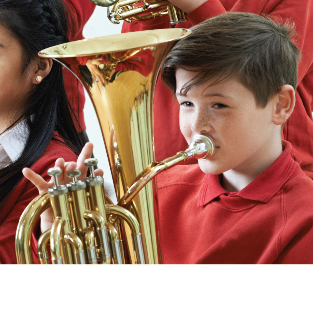 Cropped image of a school brass band showing a boy playing a tenor horn