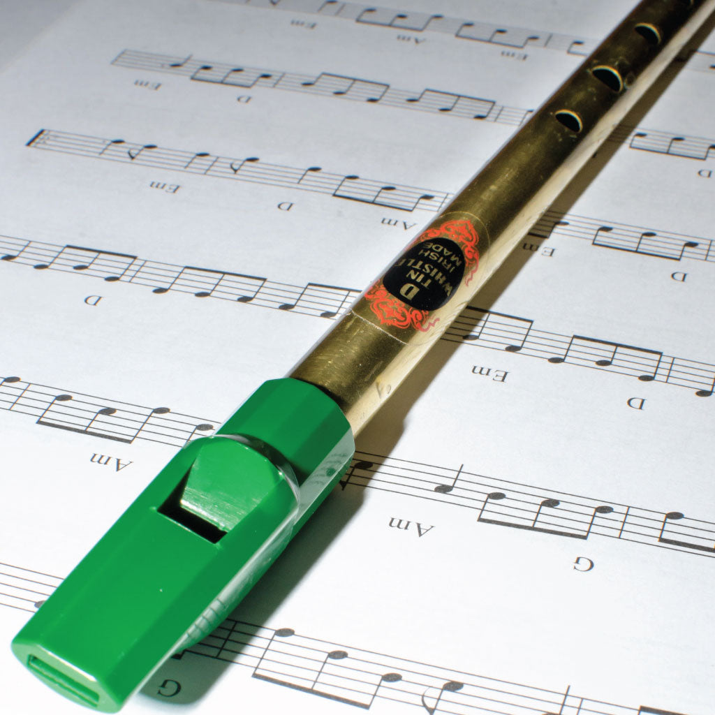 A Tin Whistle resting on some sheet music