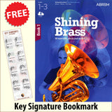 front cover of ABRSM Shining Brass Book 1 together with free Grand Staff bookmark