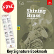 front cover of ABRSM Shining Brass Book 2 Eb Piano Accompaniment together with free Piano Clef bookmark